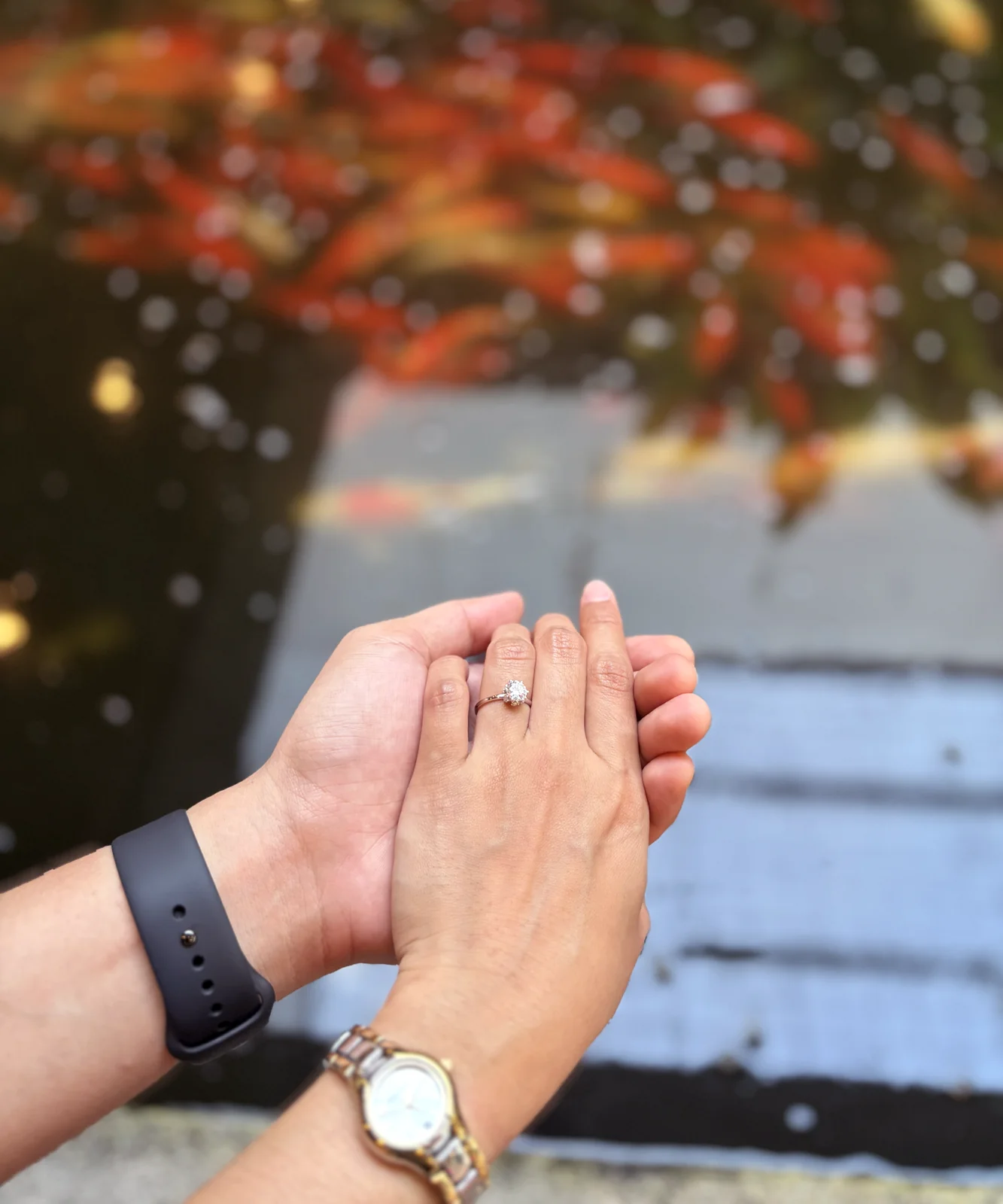 Eric and Rica holding hands, with the engagement ring